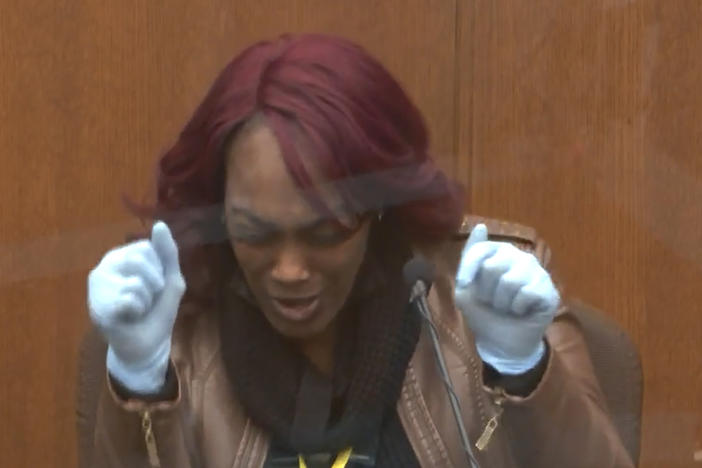 Shawanda Hill testifies Tuesday in the trial of Derek Chauvin. She said that as a police officer stood with a gun drawn outside the car she was in with George Floyd, Floyd grabbed the steering wheel and started saying, "Please, please don't kill me, please, please don't shoot me."
