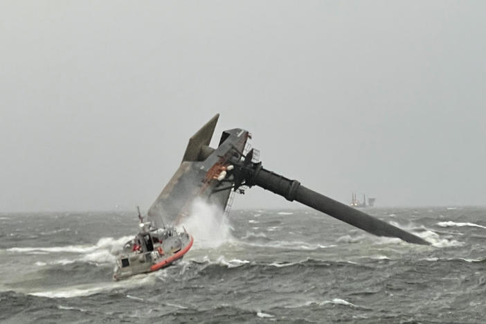 A Coast Guard Station Grand Isle boat crew heads toward a capsized commercial lift boat April 13 searching for people in the water 8 miles south of Grand Isle, Louisiana.