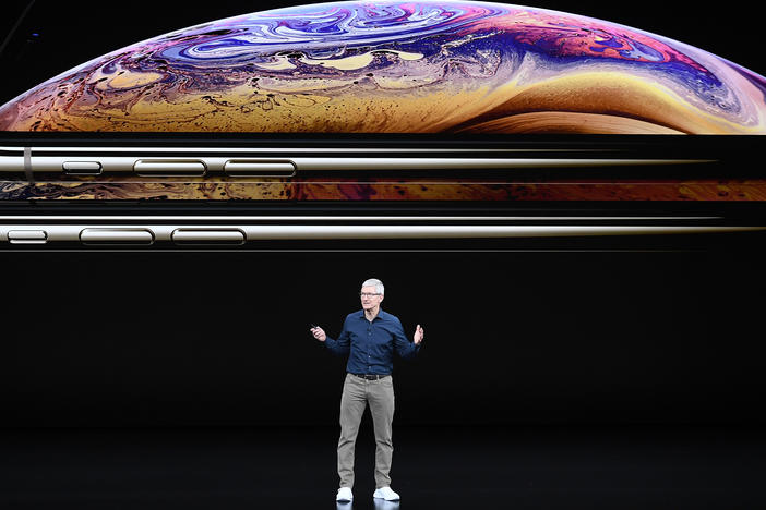 Tim Cook, chief executive officer of Apple Inc., speaks during an event in 2018. Apple is one of 310 companies calling on the Biden administration to slash carbon emissions.