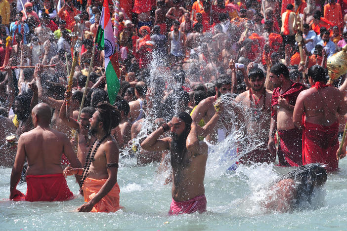 Men take a holy dip in the Ganges River on the occasion of first royal bath of Shivratri festival during Maha Kumbh Festival in Haridwar, India.