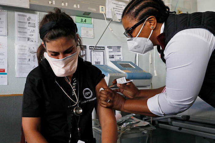 Dr. Anike Baptiste receives a dose of J&J from nurse Mokgadi Malebye at a Pretoria hospital last February. South Africa is one of the countries that announced a pause on the J&J vaccine while more research is done into potential blood clots that occurred in younger women after getting the vaccine.