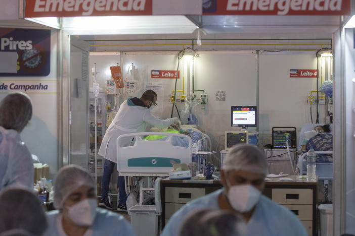 A health worker treats a COVID-19 patient at a field hospital in Ribeirao Pires, greater Sao Paulo area, on Tuesday.