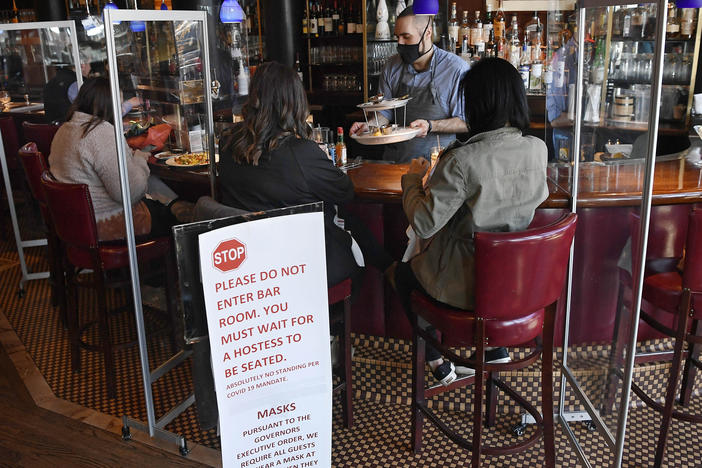 Diners eat lunch at Max's Oyster Bar in West Hartford, Conn., on March 19. Retail sales surged last month as $1,400 relief payments and easing coronavirus restrictions led shoppers to open their wallets.