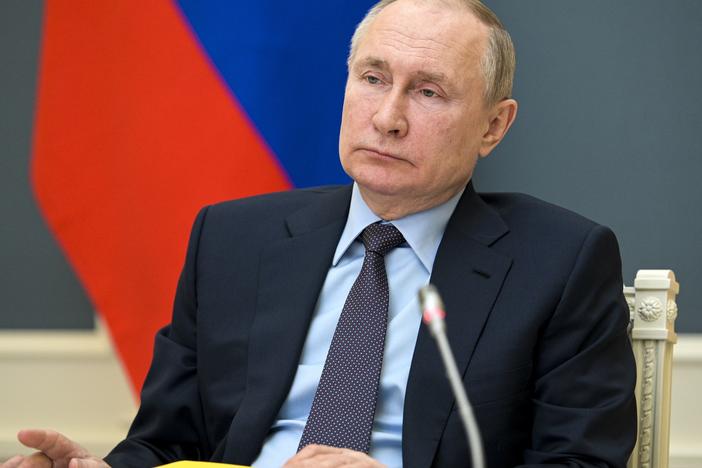 Russian President Vladimir Putin attends a meeting Wednesday via video link. The sanctions against Moscow signal that "we are going to be clear to Russia that there will be consequences when warranted," the White House press secretary says.