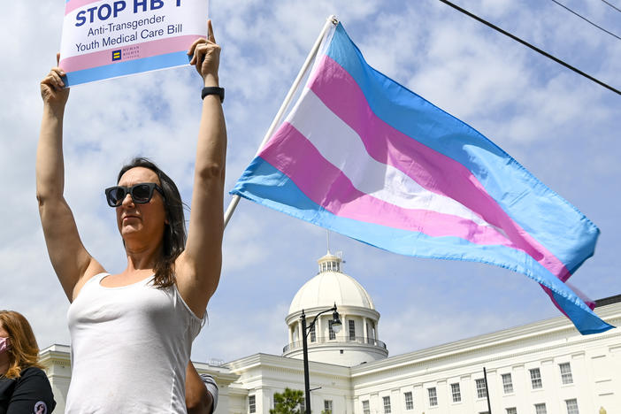 Sydney Duncan holds a sign during a rally at the Alabama State House to draw attention to legislation introduced in Alabama that's aimed at restricting transgender people's access to medical care.