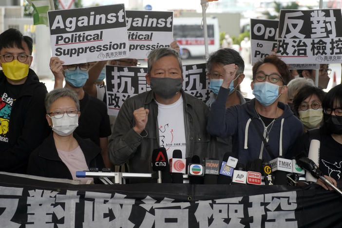 Pro-democracy activist Lee Cheuk-yan, center, arrives at a court in Hong Kong Friday.  Seven of Hong Kong's leading pro-democracy advocates, including Lee, and pro-democracy media tycoon Jimmy Lai, were sentenced Friday for organizing a march during the 2019 anti-government protests.
