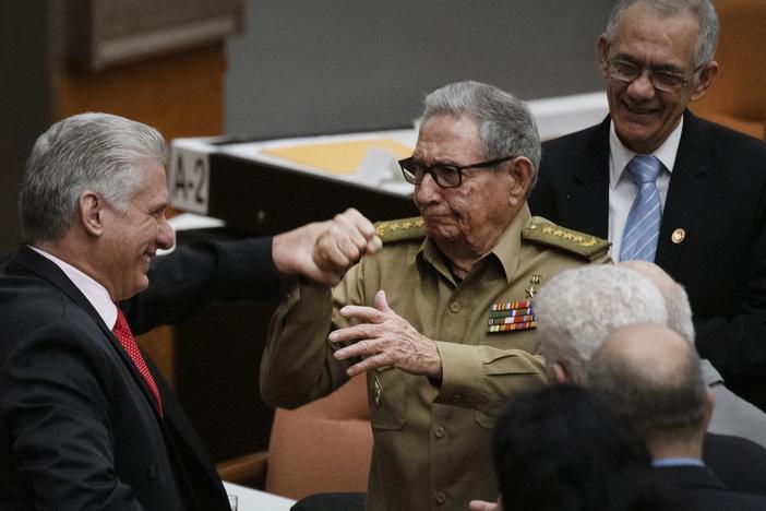 Raúl Castro, first secretary of the Cuban Communist Party and the country's former president, clasps hands with Cuban President Miguel Mario Díaz-Canel Bermúdez during the closing session at the National Assembly of Popular Power in 2019 in Havana.