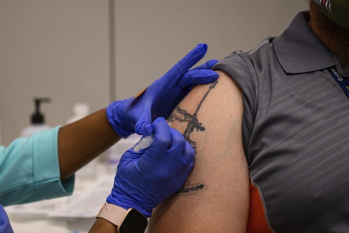 A Georgia Tech employee receives a Pfizer coronavirus vaccination on the campus April 8. For a number of Americans, getting their shots is as easy as showing up to their workplace as some companies and institutions provide on-site vaccinations to their employees.
