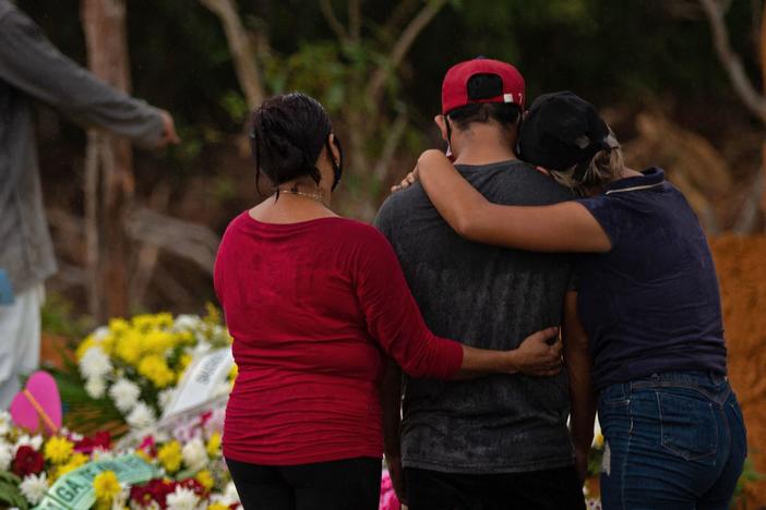 Relatives attend a COVID-19 victim's burial at a cemetery in Manaus, Amazonas state, Brazil, on Thursday.