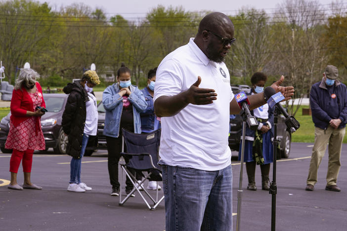 Pastor Denell Howard leads a prayer Saturday at a vigil at Olivet Missionary Baptist Church in Indianapolis for the victims of the shooting Thursday at a FedEx facility.