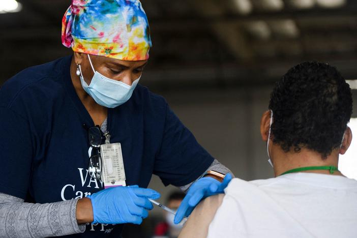 A nurse administers the Moderna COVID-19 vaccine at a Veterans Administration Long Beach Healthcare System pop-up vaccination site at the Dae Hueng Presbyterian Church on Saturday in Gardena, Calif. More than half of U.S. adults have now received at least one vaccine dose.