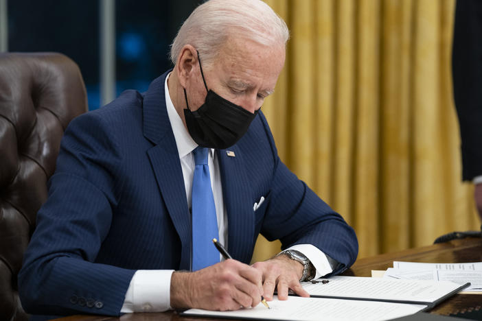 President Biden signs an executive order on immigration in February in the Oval Office.
