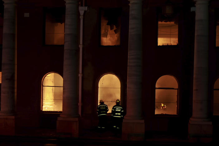 Firefighters douse the destroyed Jagger Library at the University of Cape Town, South Africa. A wildfire raging on the slopes of Cape Town's Table Mountain spread to the university, forcing the evacuation of students.