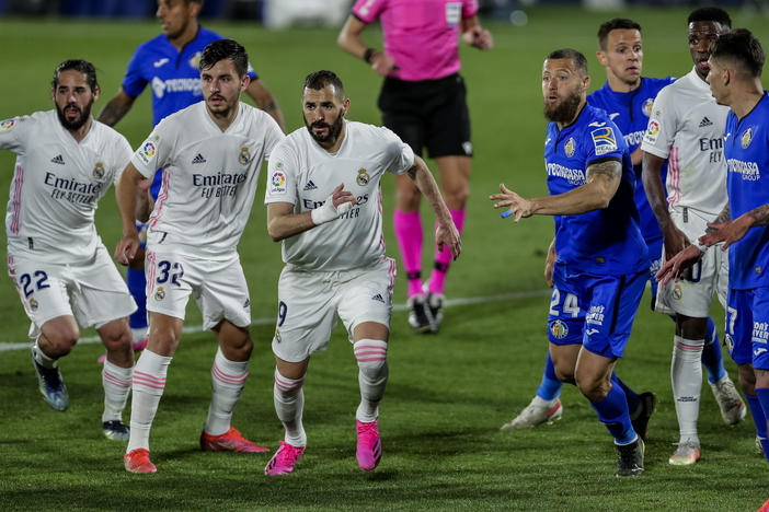 Real Madrid players, left, duel with Getafe players during the Spanish La Liga soccer match at the Alfonso Perez stadium in Getafe, Spain, Sunday.