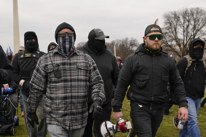 Proud Boy members Joseph Biggs (left) and Ethan Nordean, carrying a megaphone, walk toward the U.S. Capitol on Jan. 6. A federal judge ordered them detained pending trial given the conspiracy charges against them.