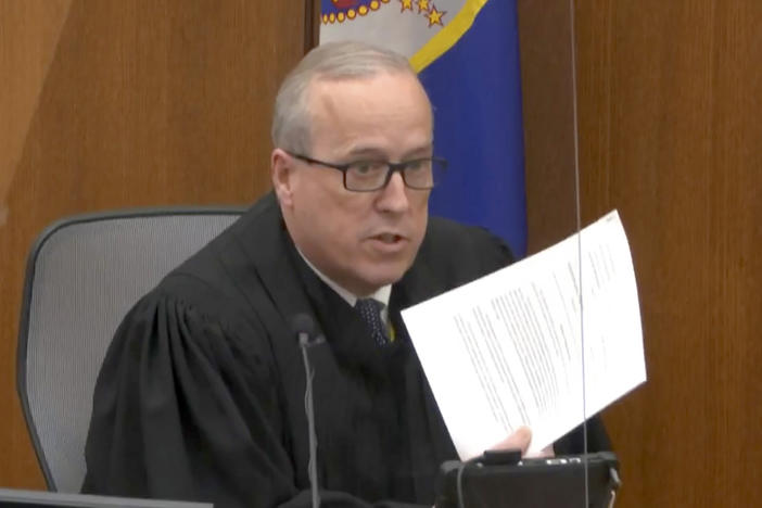 In an image taken from video on Monday, Hennepin County Judge Peter Cahill reads instructions to the jury before closing arguments in the trial of former Minneapolis police officer Derek Chauvin.