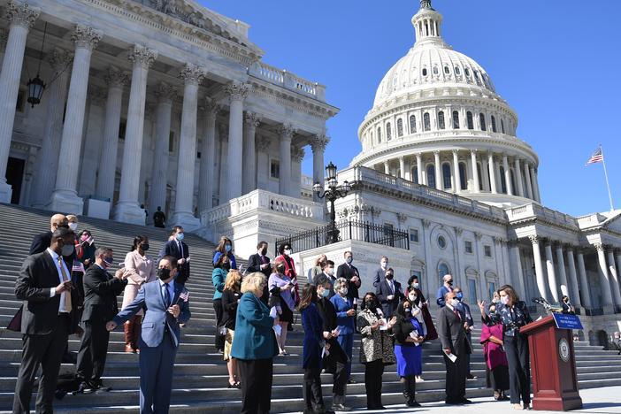 House Speaker Nancy Pelosi (right) speaks outside the U.S. Capitol in March with other members of the U.S. House of Representatives, the size of which has stayed at 435 voting members for decades.