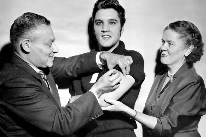 Elvis Presley got his polio vaccination from Dr. Harold Fuerst and Dr. Leona Baumgartner at CBS' Studio 50 in New York City on Oct. 28, 1956. The chart-topping singer took part in a March of Dimes campaign to convince teens to get vaccinated.