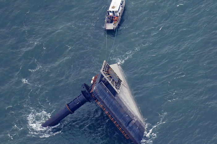 A rescue boat is seen next to the capsized lift boat Seacor Power seven miles off the coast of Louisiana in the Gulf of Mexico Sunday. The vessel capsized during a storm last Tuesday.