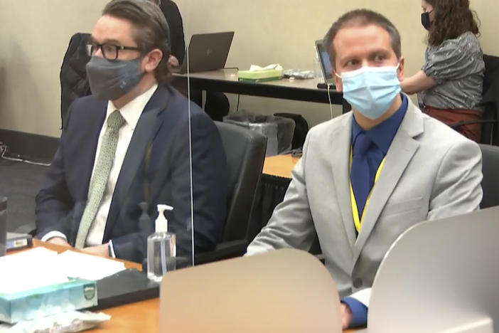 Defense attorney Eric Nelson (left) and former Minneapolis police officer Derek Chauvin listen to Judge Peter Cahill read instructions to the jury before closing arguments Monday.
