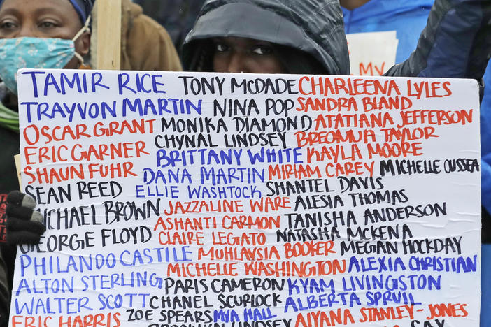 A sign at a June 2020 protest against racial injustice and police violence in Seattle bears the names of people killed by police.