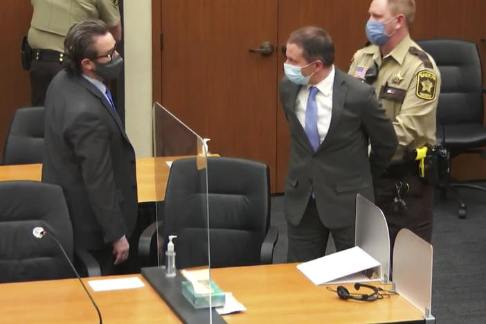 Former Minneapolis police officer Derek Chauvin is taken into custody as his attorney, Eric Nelson, looks on after the verdicts were read on Tuesday at Chauvin's trial for the 2020 death of George Floyd.