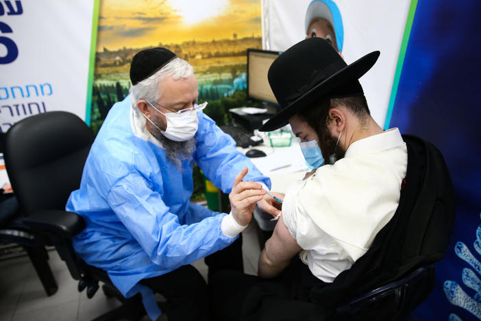 An Ultra-Orthodox Jewish man receives a dose of the Pfizer-BioNtech vaccine in the Israeli city of Bnei Brak in February.