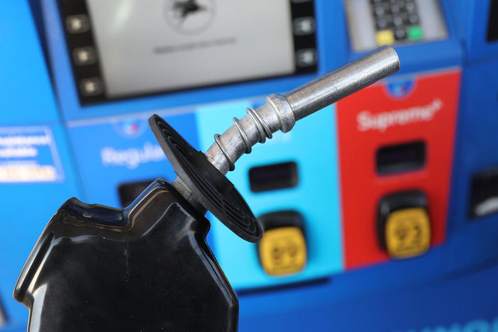 A gas pump nozzle is seen at a Miami gas station in 2018. Some activist shareholders are pushing companies to tie executive compensation to meeting climate targets.