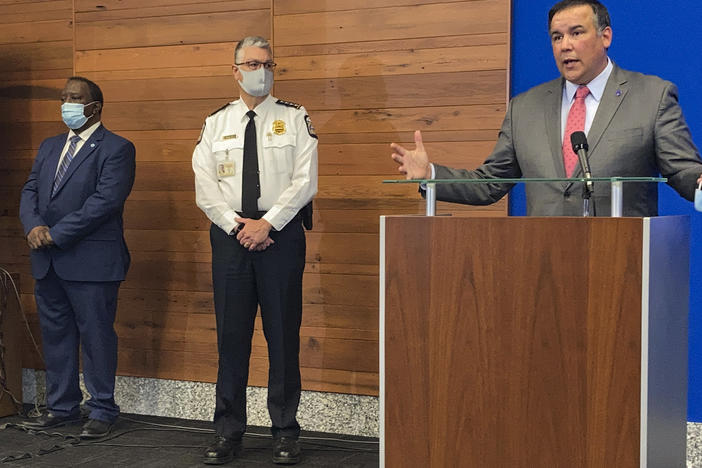 Columbus, Ohio, Mayor Andrew Ginther speaks during a news conference Wednesday about the fatal police shooting of 16-year-old Ma'Khia Bryant on Tuesday. Columbus Public Safety Director Ned Pettus (left) and interim Police Chief Michael Woods listen.