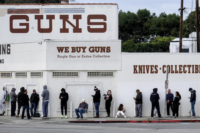 People wait in line to enter a gun store in Culver City, Calif., on March 15, 2020.