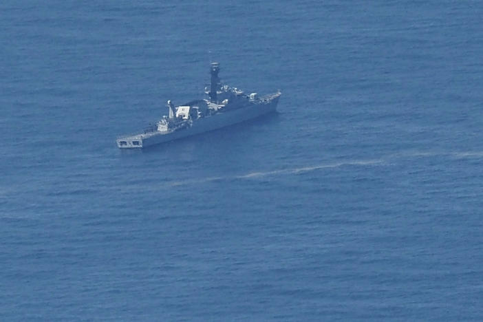 An Indonesian navy ship searches for the submarine KRI Nanggala 402 that went missing this week in the waters off Bali.