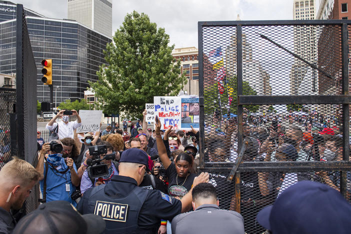 Protesters gather outside the entrance to a rally for then-President Donald Trump in June in Tulsa, Okla. A new state law increases penalties for protesters who block public roadways and grants legal immunity to drivers who unintentionally harm them as they try to flee.