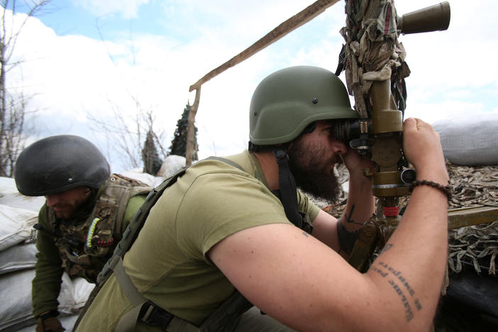 A Ukrainian serviceman looks through a periscope at his position on the fronline against Russia-backed separatists, not far from Donetsk, Ukraine, on Thursday.
