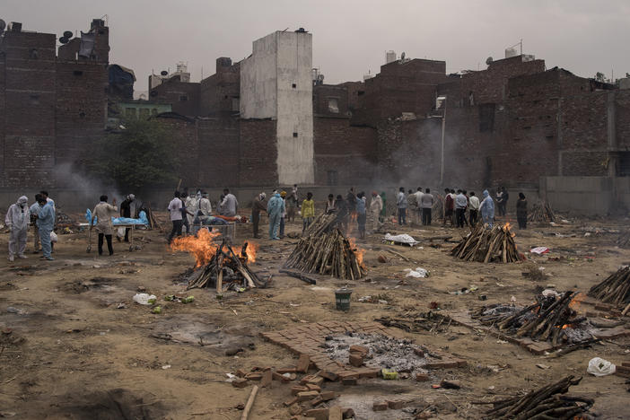 Funeral pyres for patients who died of COVID-19 are seen burning this week at a makeshift crematorium in New Delhi.