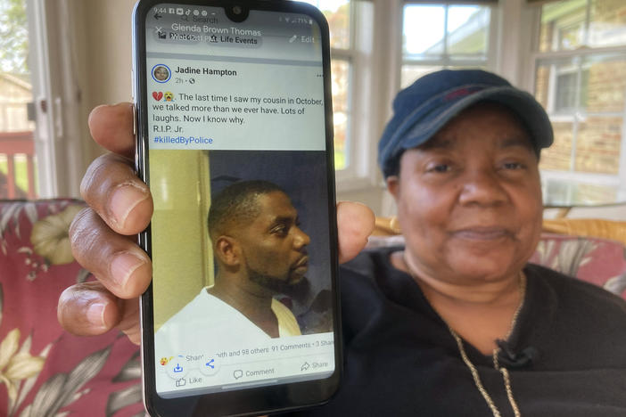 Glenda Brown Thomas displays a photo of her nephew, Andrew Brown Jr., on Thursday. He was shot and killed Wednesday by a sheriff's deputy who was attempting to execute a warrant.