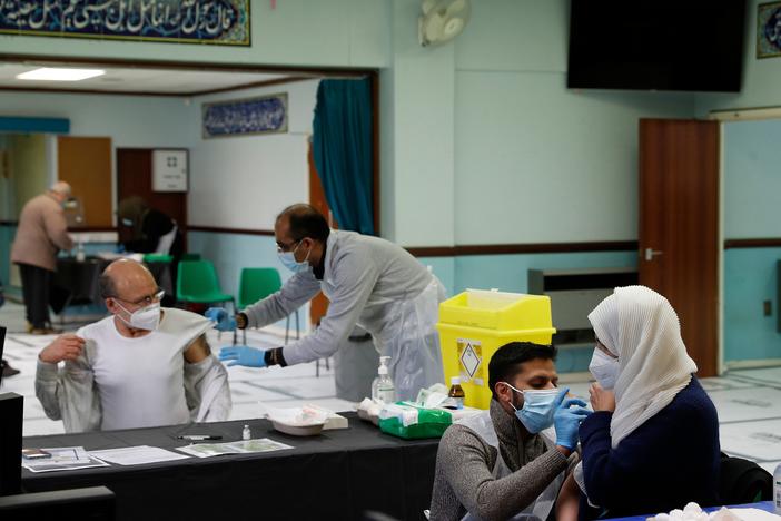 People receive the AstraZeneca COVID-19 vaccine at the Al-Abbas Islamic Center, converted into a vaccination clinic in Birmingham, England, in January. Sheikh Nuru Mohammed, the imam at the mosque, recognized many of his congregants were hesitant to get the "jab," as it's called, due to false rumors and distrust of government. So he began to fight disinformation during his sermons.