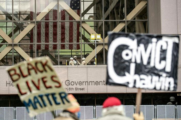 People wait for the verdict in Derek Chauvin's trial over the death of George Floyd outside the Hennepin County Courthouse in Minneapolis on Tuesday.