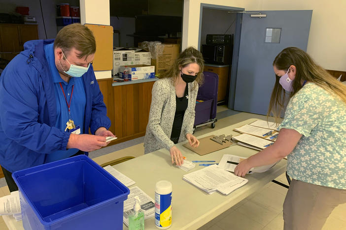 Holmes County, Ohio, General Health District staff members (from left) Michael Derr, Jennifer Talkington and Abbie Benton prepare materials for a COVID-19 vaccine clinic this month inside St. Peter's Catholic Church in Millersburg.