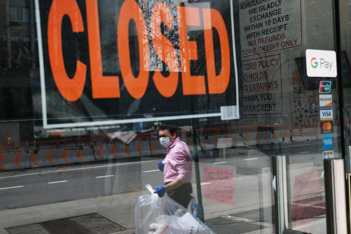A closed sign is displayed in the window of a business in a nearly deserted lower Manhattan on April 17, 2020, in New York. Many small businesses benefited from a government emergency loan program during the pandemic, but its effectiveness is still in doubt.