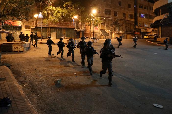 Israeli security forces on a street during clashes with Palestinian youth in Hebron on April 25.