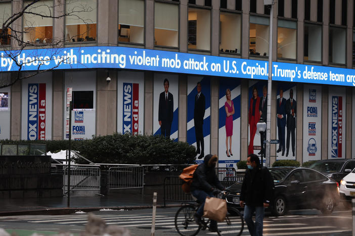 News headlines on the impeachment trial of Donald Trump are displayed outside Fox headquarters in February in New York City.