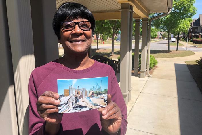 Jeanette Barnes displays an image showing the damage done to her apartment 10 years ago during the deadly Tuscaloosa, Ala., tornado.