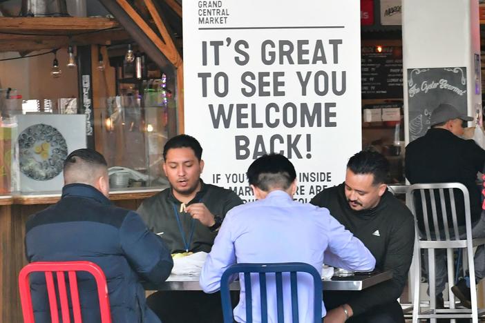 People enjoy lunch at Grand Central Market as indoor dining reopens in Los Angeles on March 15. The U.S. economy expanded at a rapid pace in the first three months of the year and is expected to grow at its fastest rate since 1984.