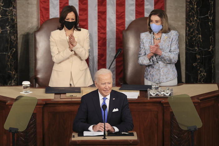 In a historic first, President Biden was flanked by two women — House Speaker Nancy Pelosi and Vice President Harris — as he addressed a joint session of Congress at the U.S. Capitol on Wednesday.