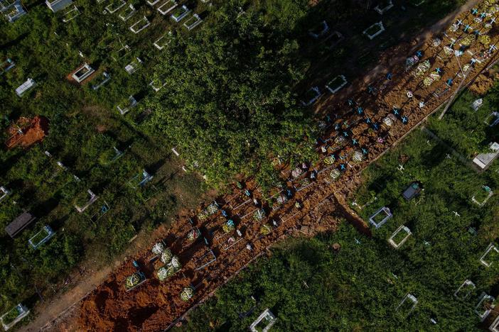With little space left at Nossa Senhora Aparecida cemetery in Manaus, Brazil, graves of COVID-19 victims line a street, seen in an aerial photo taken on Thursday as the country passed 400,000 virus deaths.
