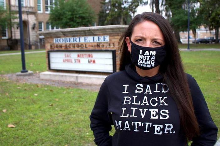 Amy Donofrio stands in front of Robert E. Lee High School in Jacksonville, Fla. She was suspended from teaching duties after she refused to take down a Black Lives Matter flag from outside her classroom.