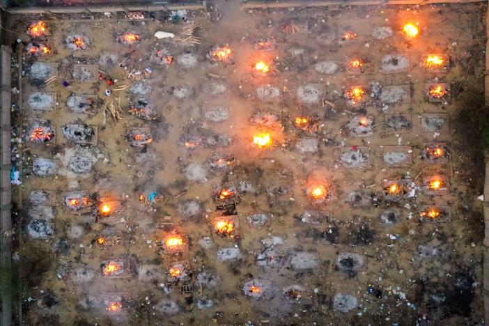 Victims of COVID-19 are cremated in funeral pyres this week in New Delhi. Scientists says the real death toll and number of infections are likely much higher than what the Indian government is reporting.