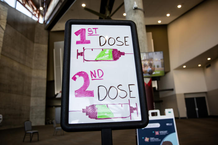 Signs direct people arriving to get COVID-19 vaccines last week at the Mountain America Expo Center in Sandy, Utah.