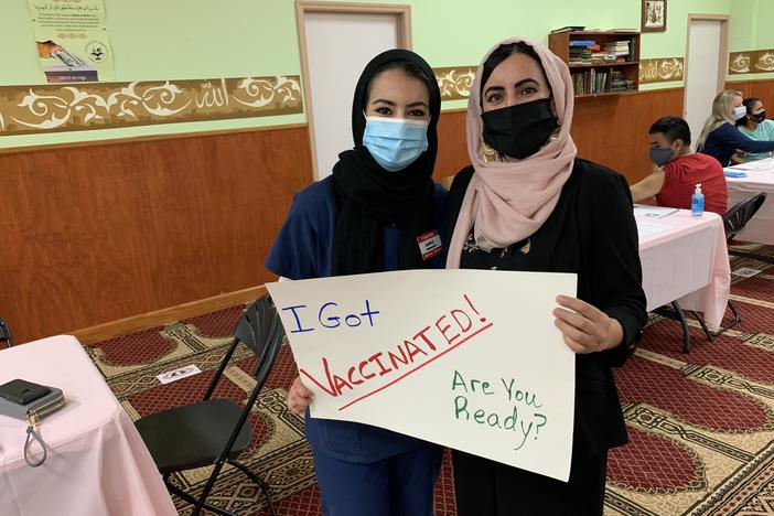 Sumaya Muhamed and her mother, Suad Abdulla, tout the latter's second vaccine dose at the Salahadeen Center in Nashville, Tenn. After weeks of affectionate cajoling and patient explanation, Muhamed convinced her mother to get the shot.