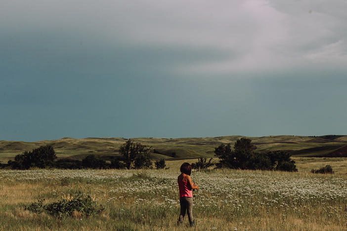 Born and raised on the Cheyenne River Reservation, a sovereign Lakota nation in South Dakota, Dawnee LeBeau is <em>Oóhenuŋpa Itázipčo</em> (two kettle and without bows) of the <em>Tetonwan Oyate</em> (people of the plains). After losing her father, she found comfort in doing things she did with him, like identifying plants. LeBeau was doing that with family when she made this image of her niece.